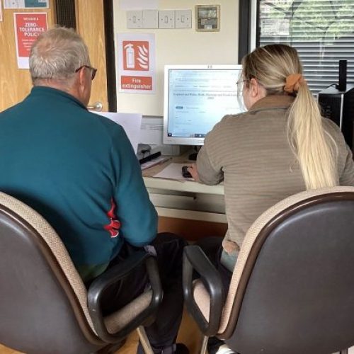 Two people at a computer at Leicestershire and Rutland Family History Research Centre